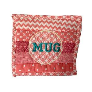 Handmade quilted mug rug different shades of pink and "MUG" embroidered in blue